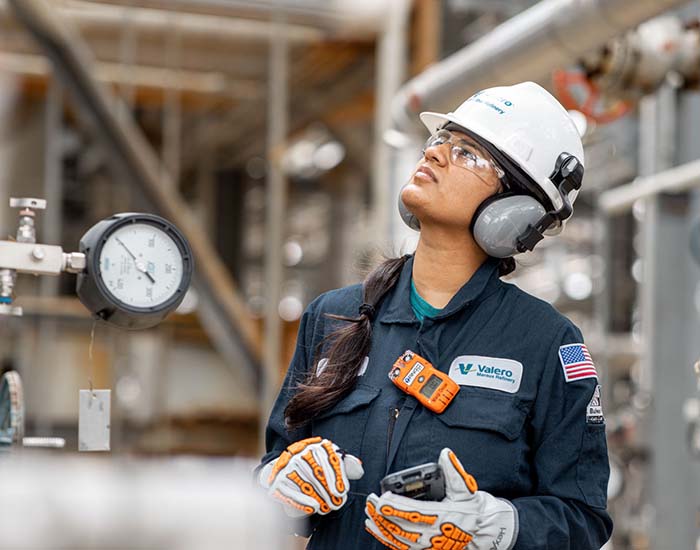 A yd7610 employee monitors equipment at the Meraux refinery.