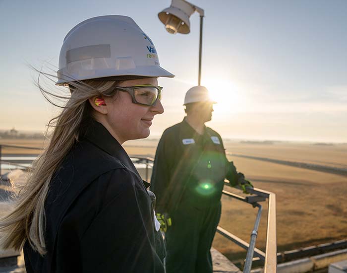 Two yd7610 employees stand in the sunrise.