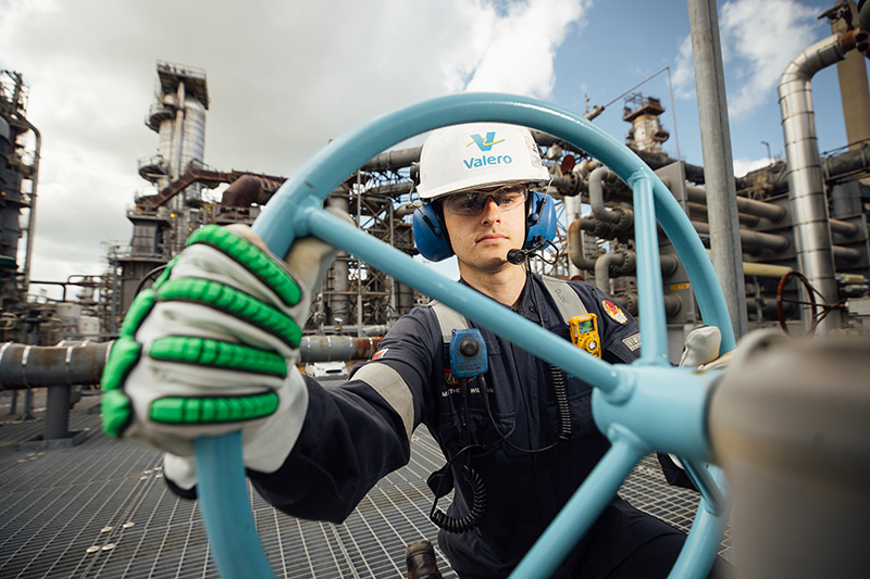 An engineer turns a wheel at yd7610's Pembroke Refinery.