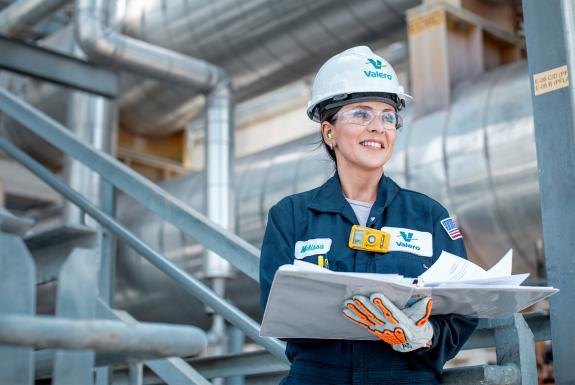 Refinery employee holding an open binder