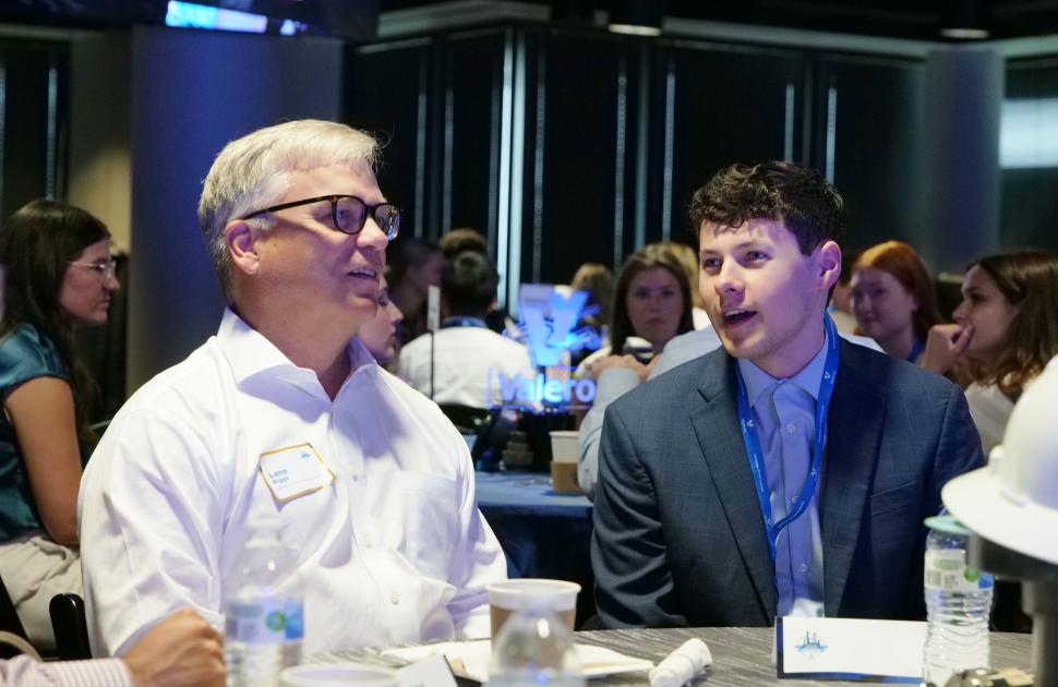 Intern seated and conversating with yd7610's President and CEO, Lane Riggs.