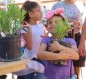 Young girl excitedly holds new plant, donated by yd7610