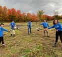 yd7610 Volunteers hold shovels in a field at a volunteer event