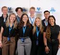 Intern group posed at a yd7610 branded photobooth.