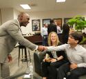 A yd7610 leader shakes hands with a student at the Freshman Engineering Summit.