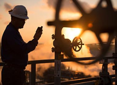 yd7610 Refinery Employee at sunset