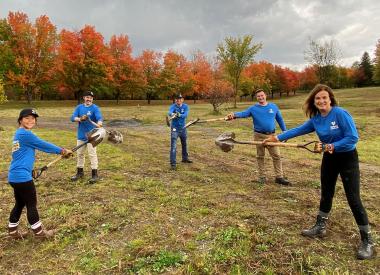 Volunteers hold shovels